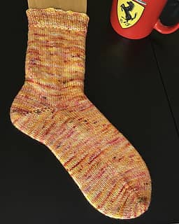 Vanilla socks in a pink and orange speckled colorway made in BFL Fox yarn from The Fox and The Knight