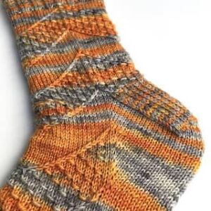 Speckled Space Socks in orange and grey from Amanda Stephens' pattern made with BFL Fox yarn from The Fox and The Knight